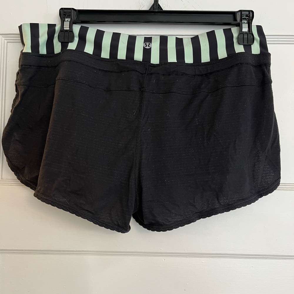 Lululemon black shorts with mint green detailed band. Size 6